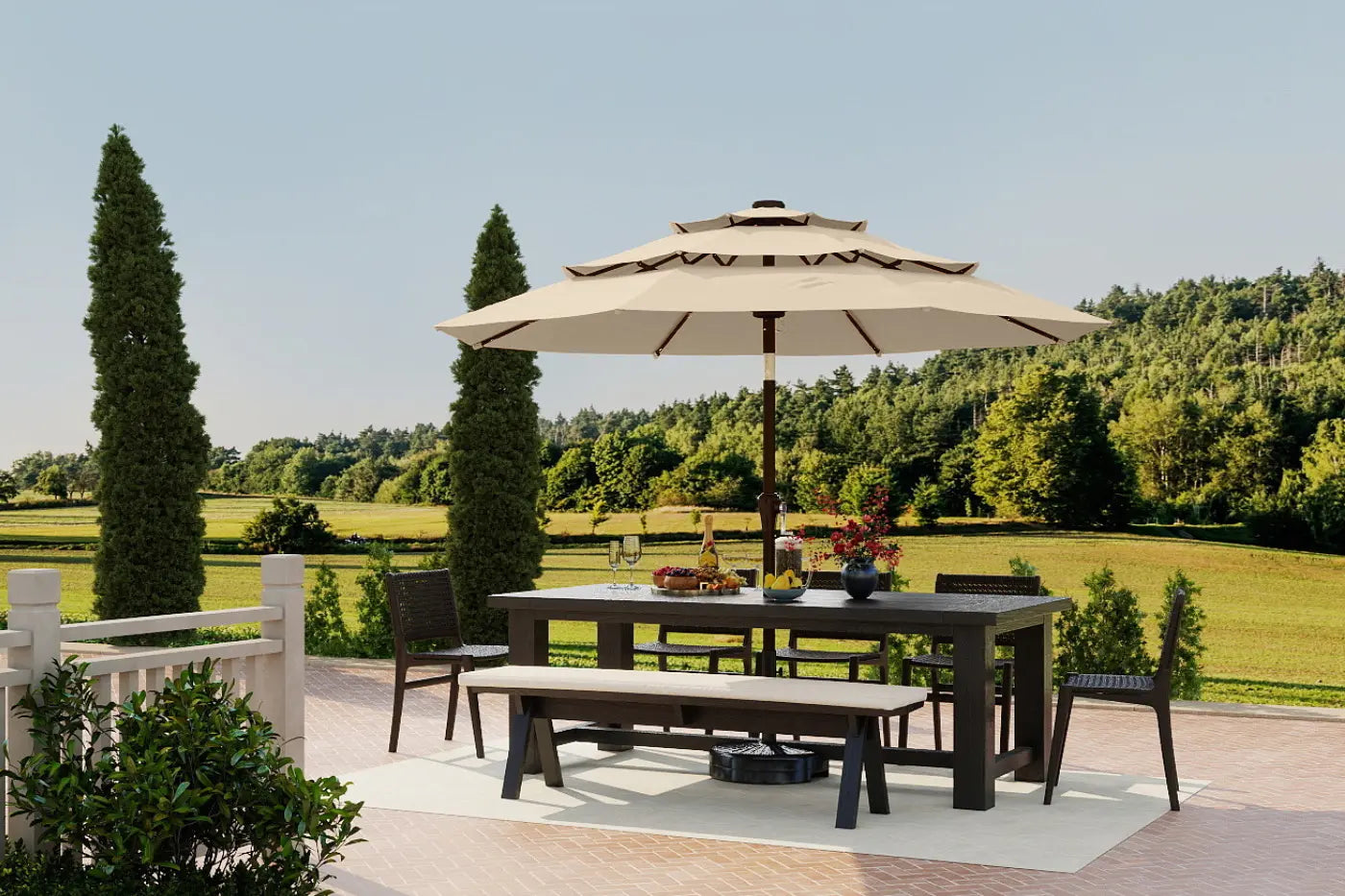 Outdoor dining set with table, chairs, and umbrella on a patio with a scenic background.
