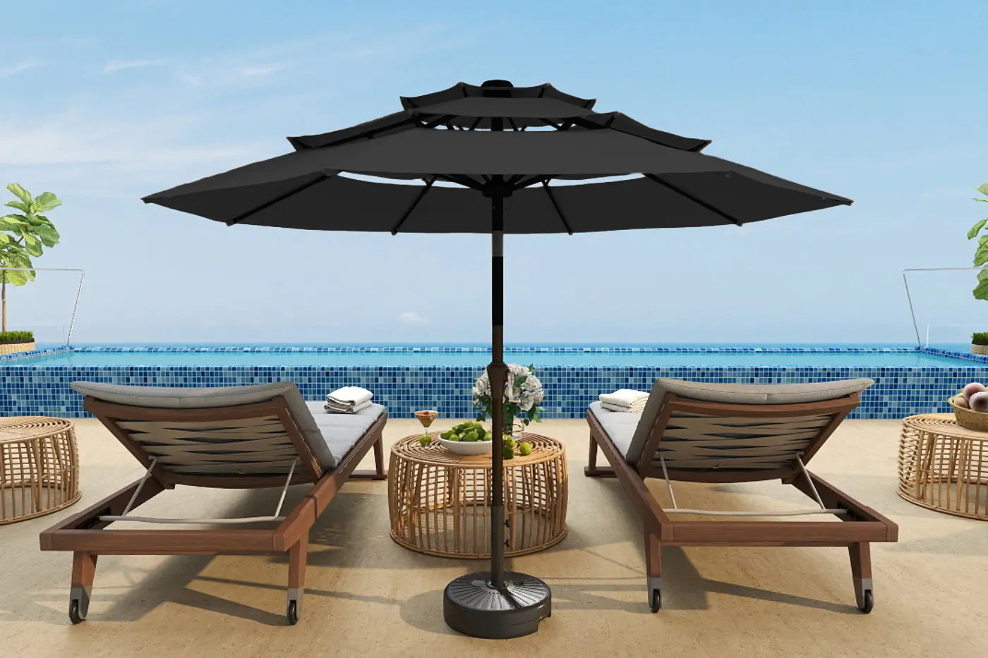 Outdoor patio set with two lounge chairs and a large black umbrella on a pool deck.