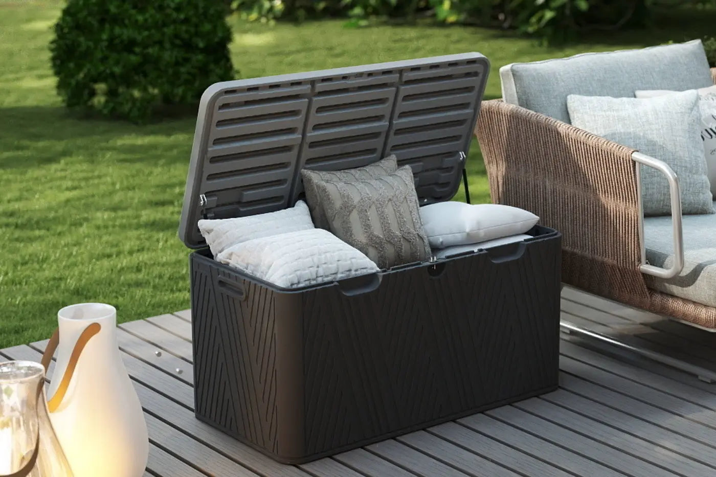 Black outdoor storage box with cushions on a wooden deck