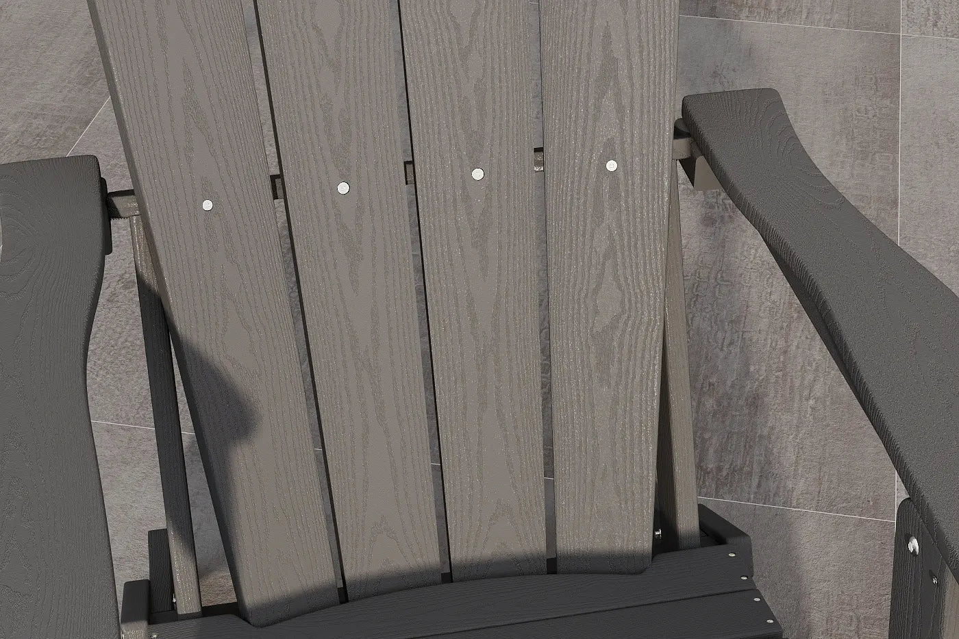 Gray wooden chair with metal brackets against a tiled wall.