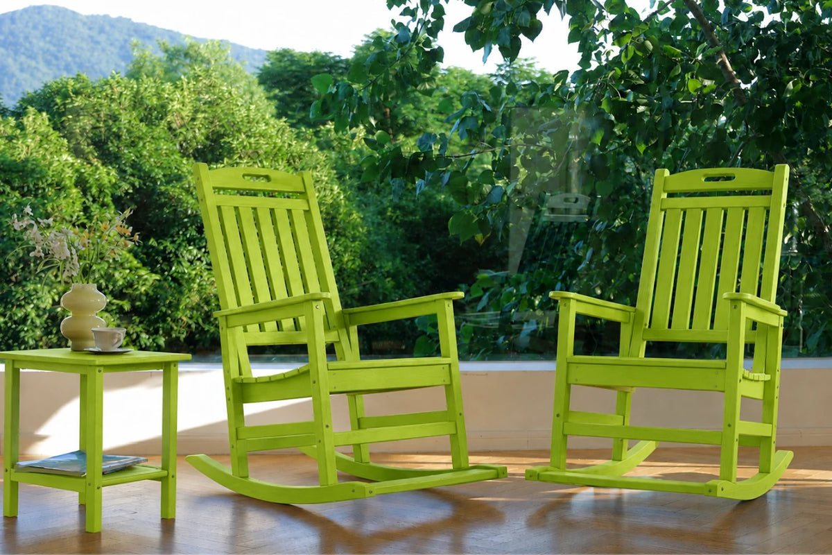 Two apple green outdoor rocking chairs with a matching side table, set on a wooden deck with a lush green garden background.