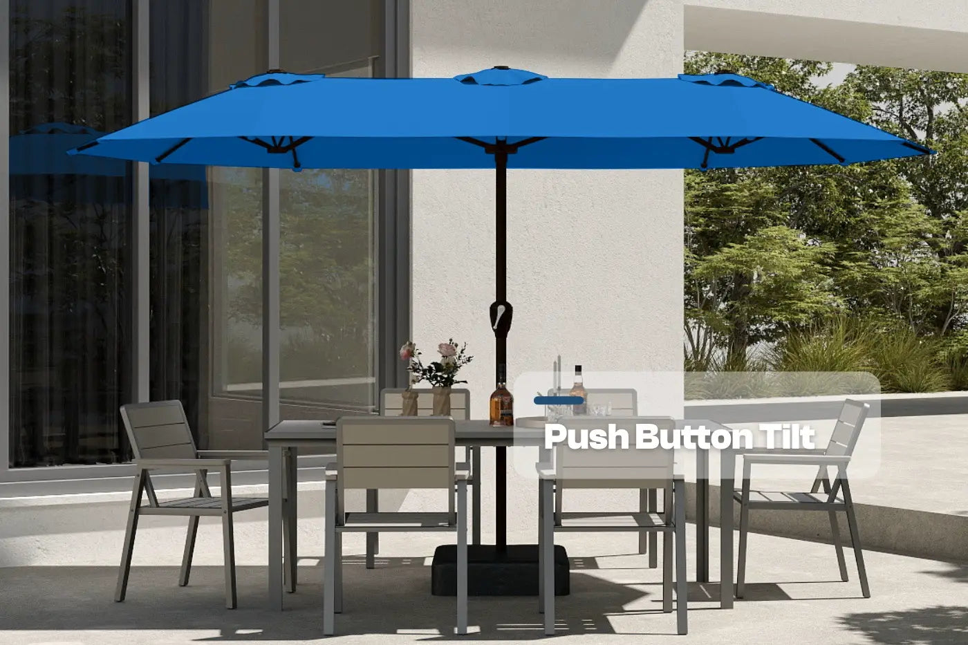 Blue patio umbrella with push-button tilt feature over a dining table and chairs on a patio.