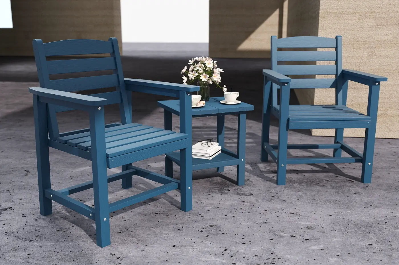 Two blue chairs with a small table on a concrete surface.