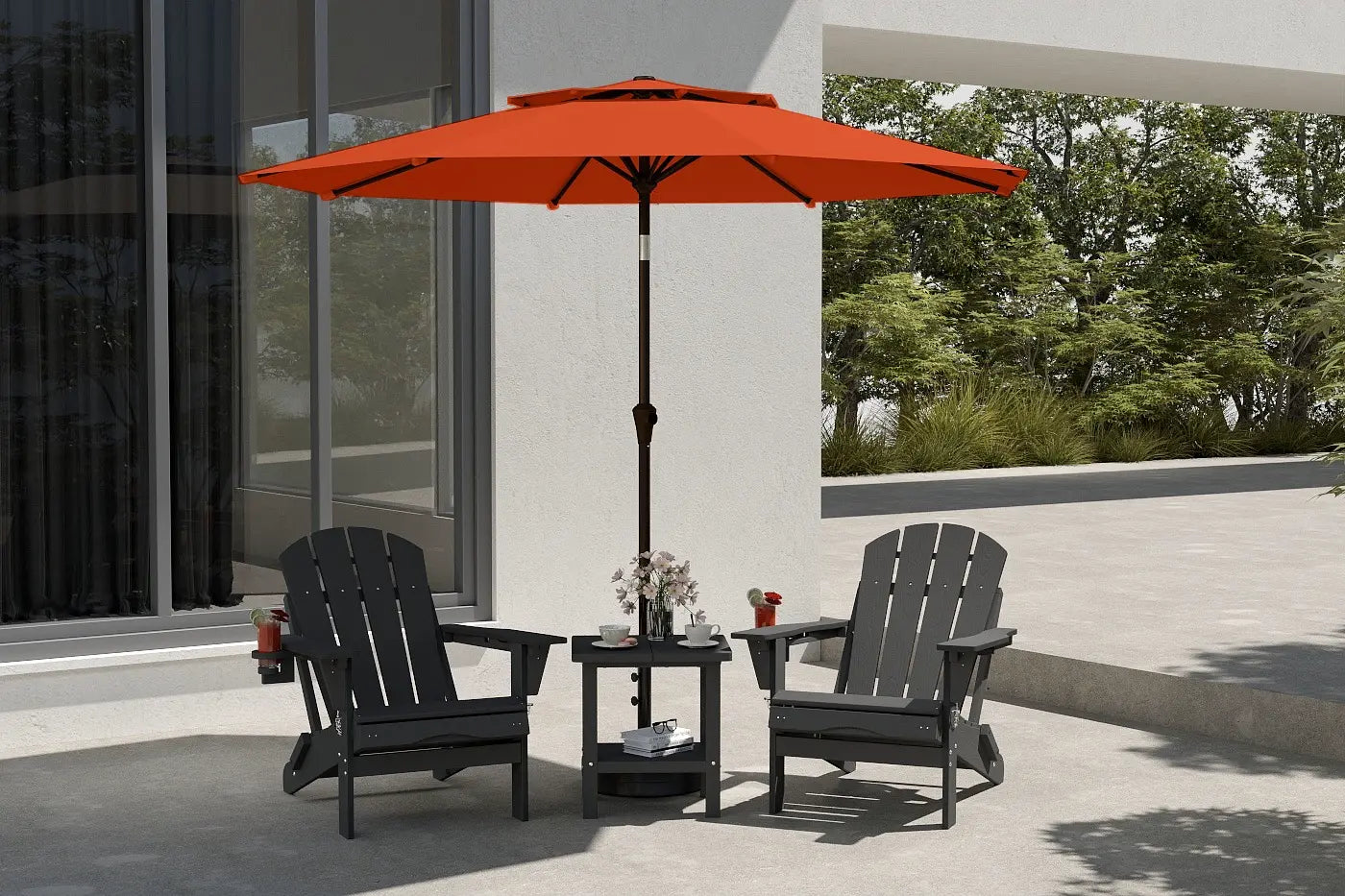 Outdoor patio set with two black chairs and a red umbrella on a patio.