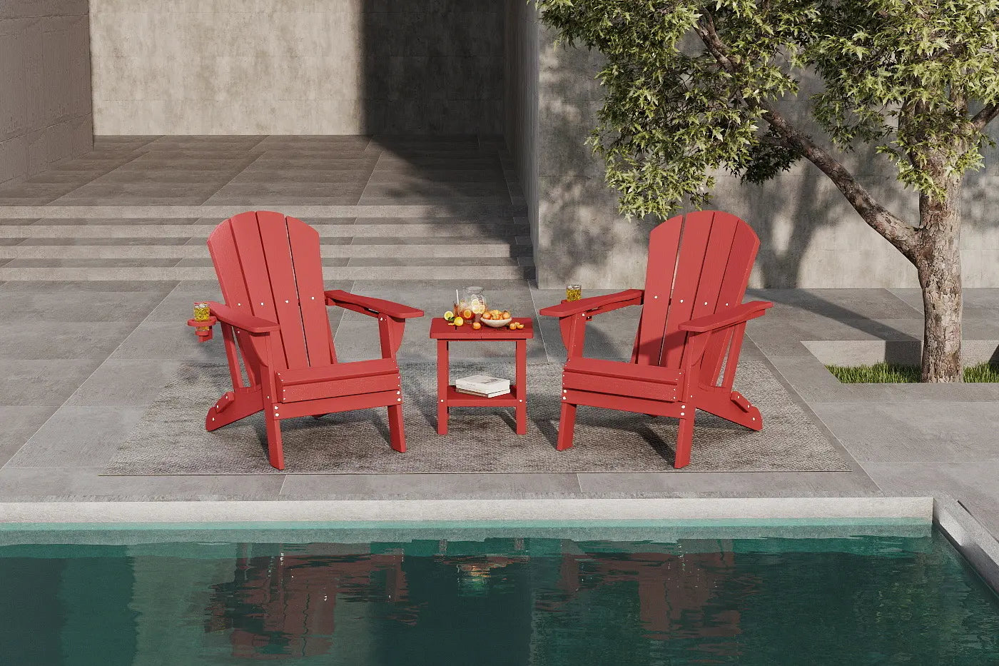 Two red Adirondack chairs with a small table by a poolside.