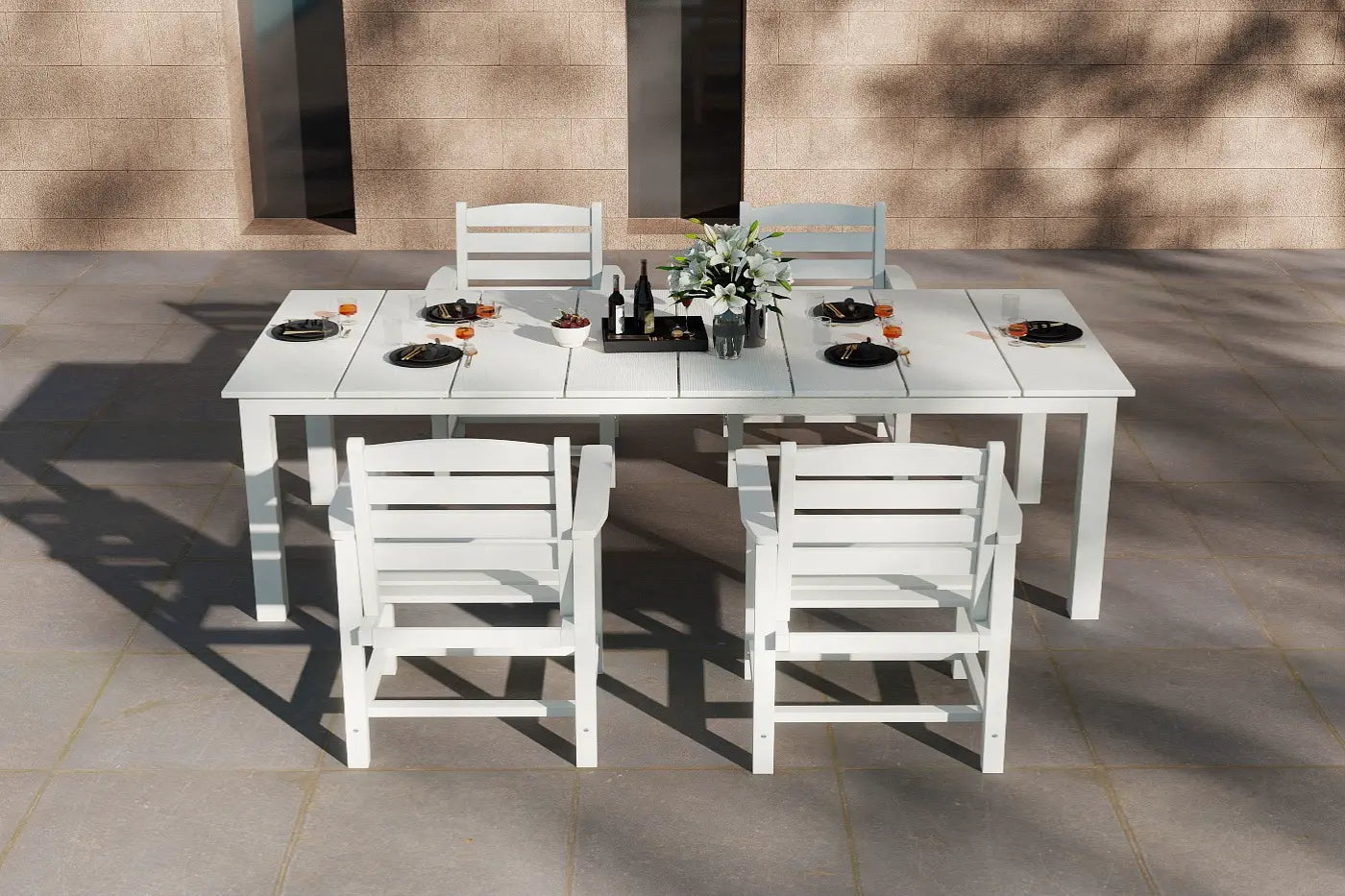 White outdoor dining table with chairs set on a patio