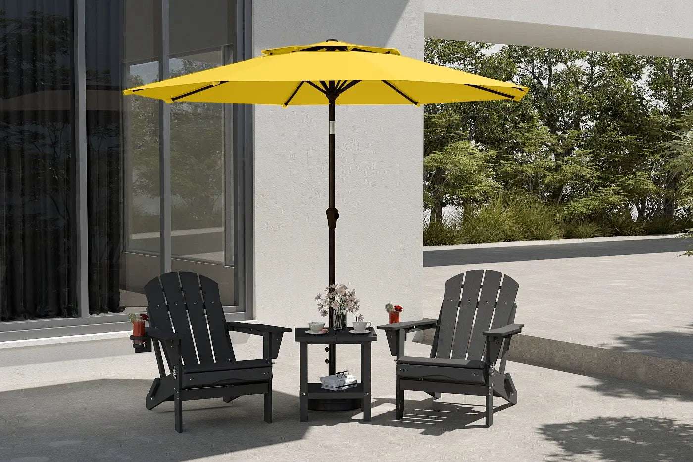 Yellow patio umbrella over two black chairs on a patio with a building and trees in the background.