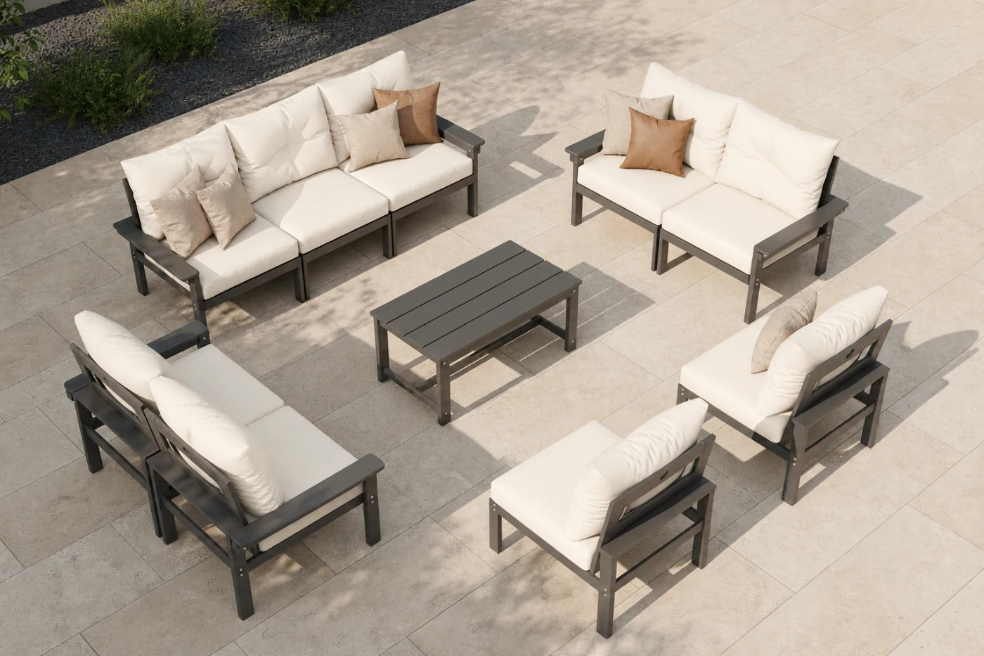 Outdoor patio furniture set with beige cushions on a stone patio.
