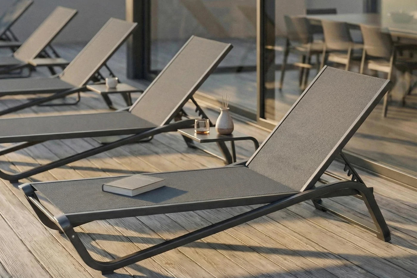 Sun loungers on a wooden deck with a blurred background