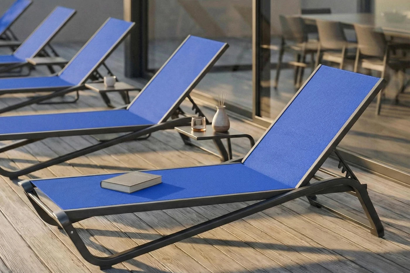 Blue lounge chairs on a wooden deck with a blurred background