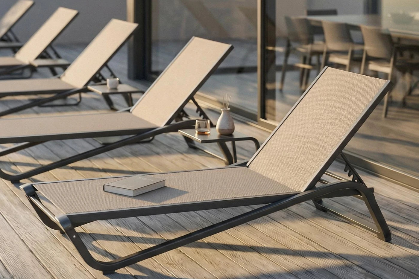 Beige lounge chairs on a wooden deck with a blurred background