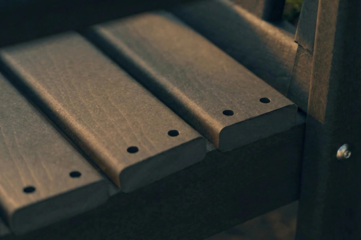 Close-up of three wooden gun magazines on a dark background