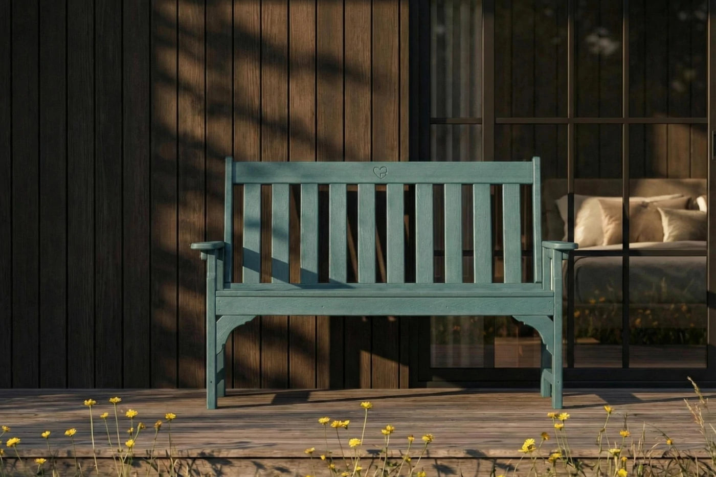 Green bench on a wooden deck with a blurred background