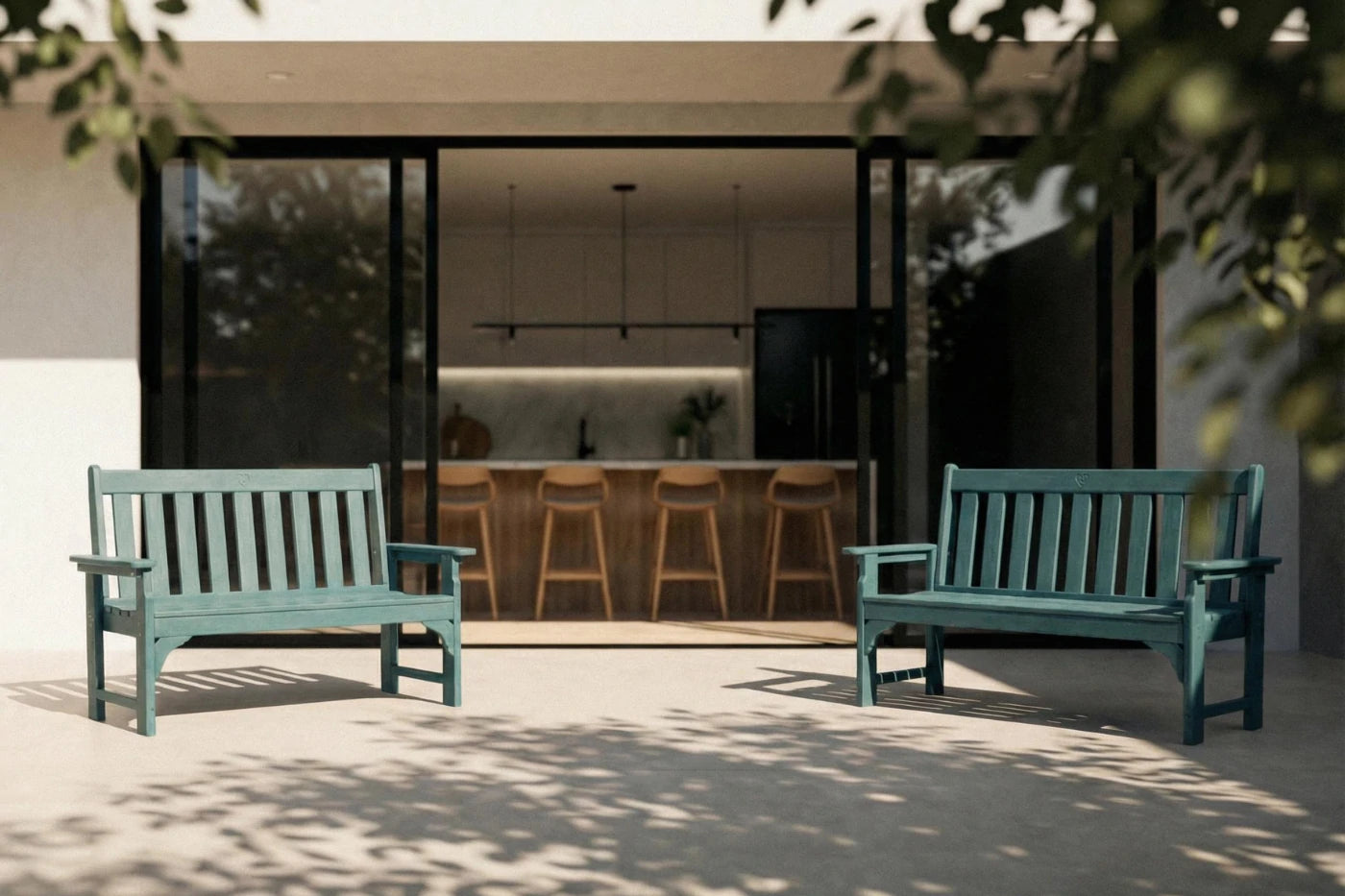Two blue benches on a patio with a modern house interior visible through large windows.