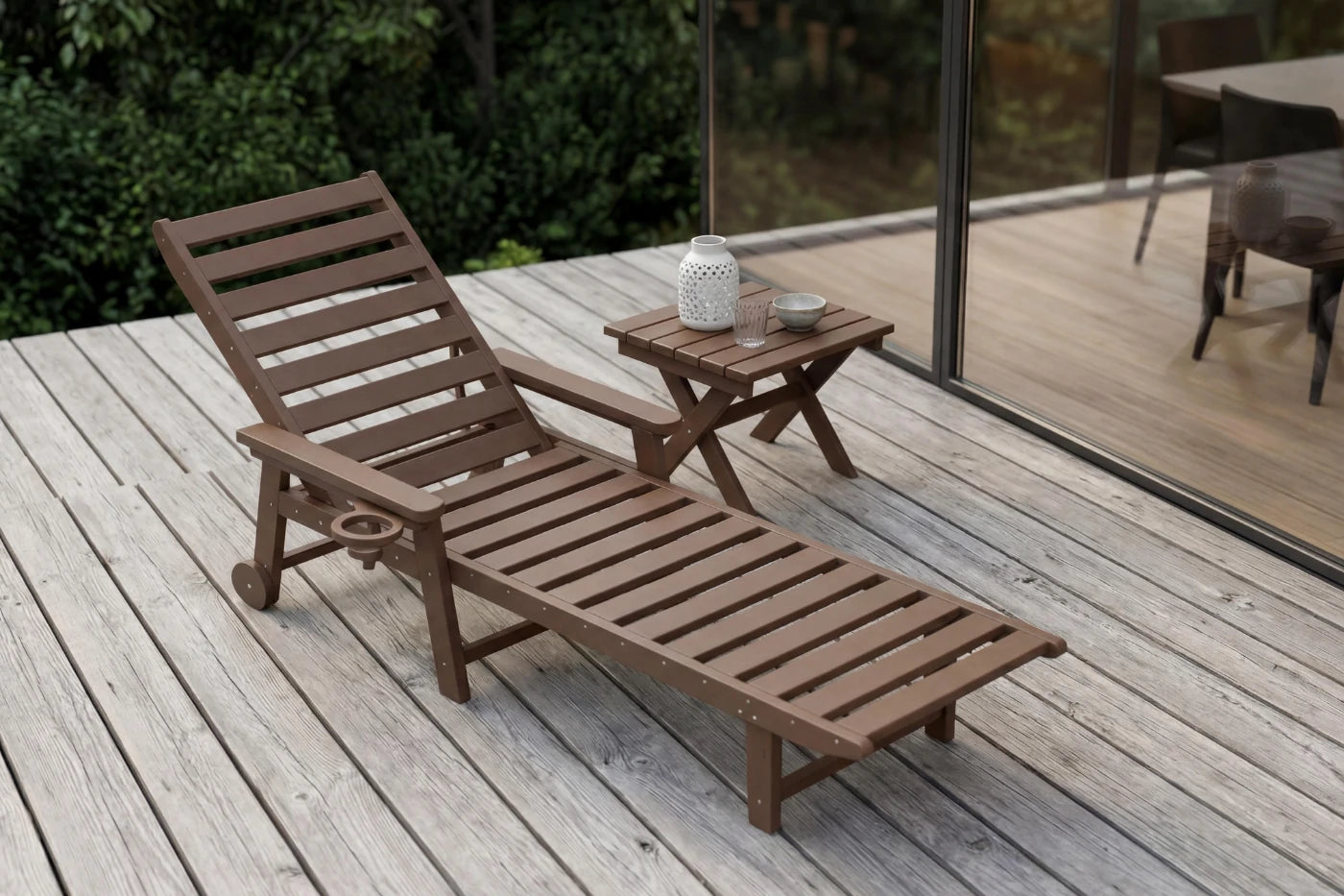 Wooden lounge chair and small table on a wooden deck with a blurred background