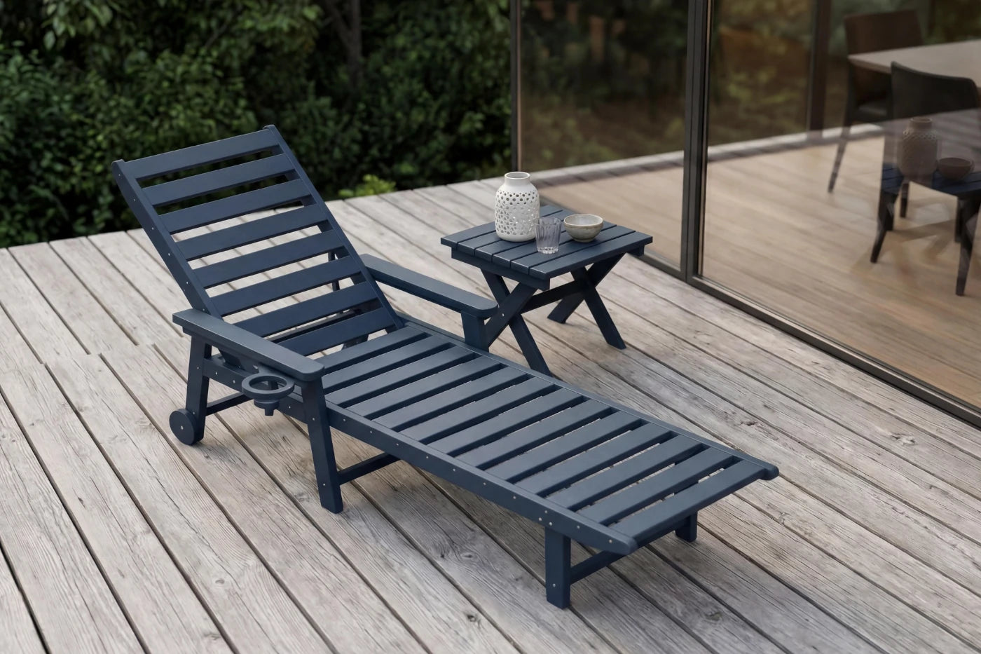 Blue lounge chair on a wooden deck with a small table and decorative items.
