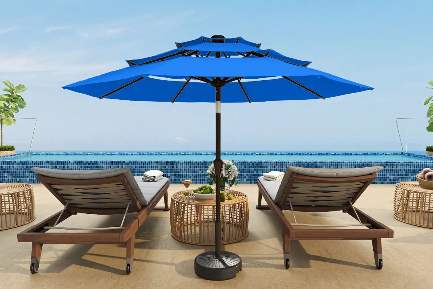 Blue patio umbrella with lounge chairs and a table on a sunny day.