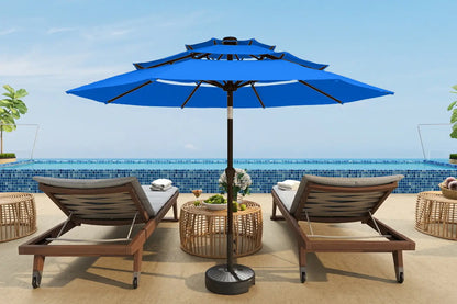 Blue patio umbrella with lounge chairs and a table on a sunny day.