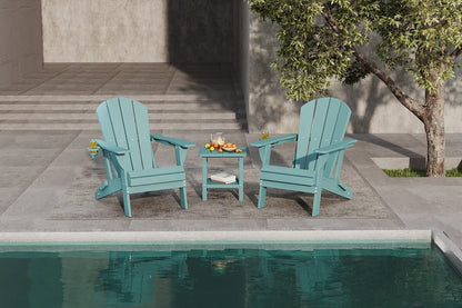 Two turquoise Adirondack chairs with a small table by a poolside.