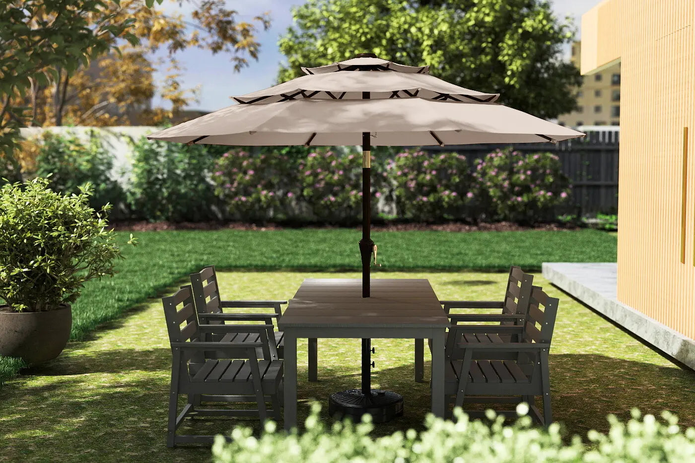 Garden setting with a patio table and chairs under a large umbrella on a sunny day.