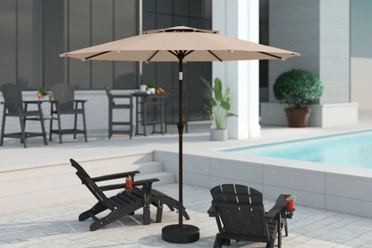Beige patio umbrella with stand on a patio area near a pool