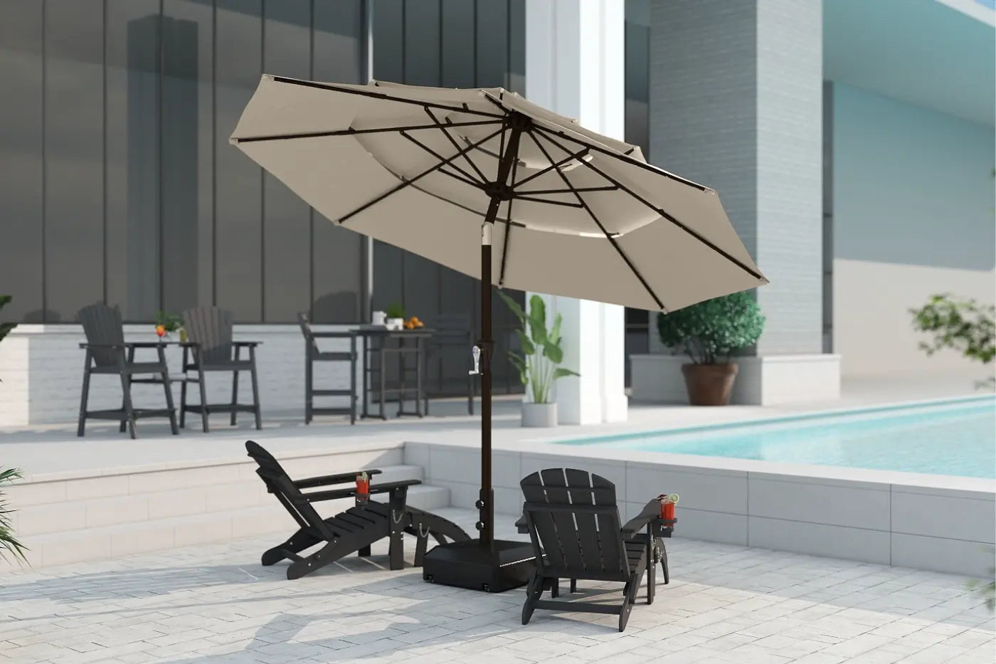 Beige patio umbrella with black stand on a patio area near a pool.