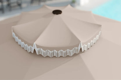 Beige patio umbrella with decorative trim on a neutral background