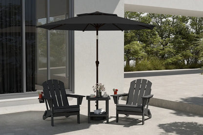 Black patio chairs with a matching table and umbrella on a patio.