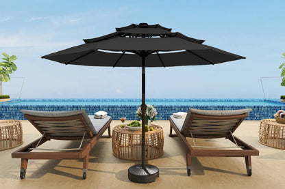 Outdoor patio set with two lounge chairs and a large black umbrella on a pool deck.