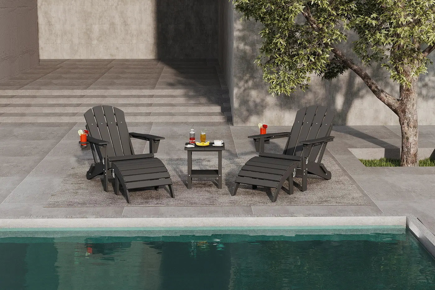 Two dark gray Adirondack chairs by a pool with a small table and drinks.