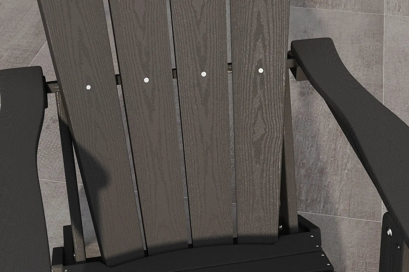Close-up of a wooden chair with metal brackets against a tiled wall.