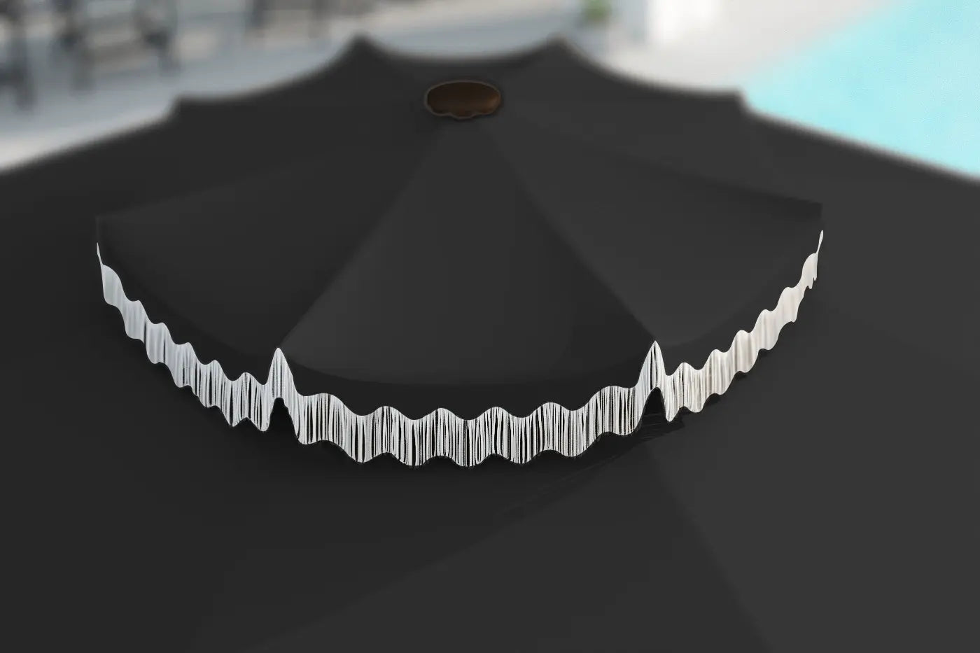Black umbrella with decorative white edge against a blurred outdoor background