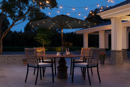 Outdoor patio setting with string lights, table, and chairs at dusk.