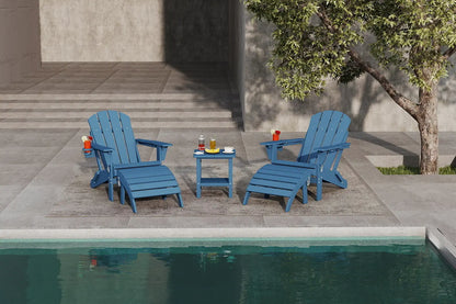 Two blue Adirondack chairs with a small table by a poolside.
