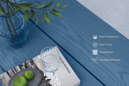 Blue wooden surface with a glass of water, green apples, and a book on a white background