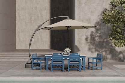 Outdoor dining set with blue chairs and a beige umbrella on a patio.