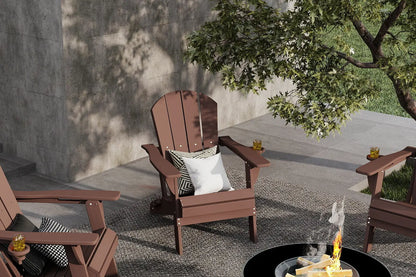 Wooden Adirondack chairs around a fire pit on a patio with trees and a wall in the background.