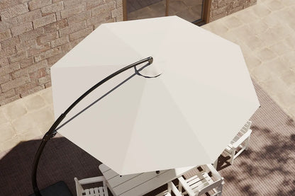 White patio umbrella on a stand with a brick wall and table in the background