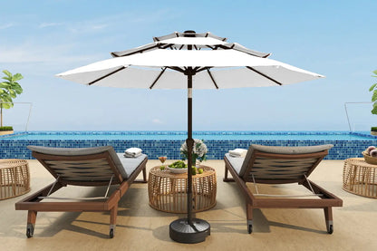Outdoor patio set with two lounge chairs and a large umbrella on a pool deck.