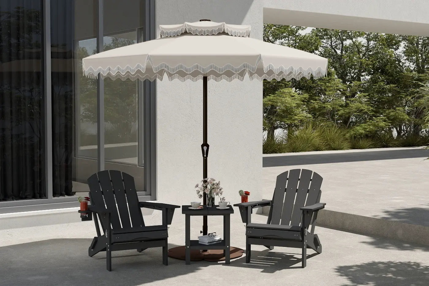 Two black Adirondack chairs with a small table and umbrella on a patio.
