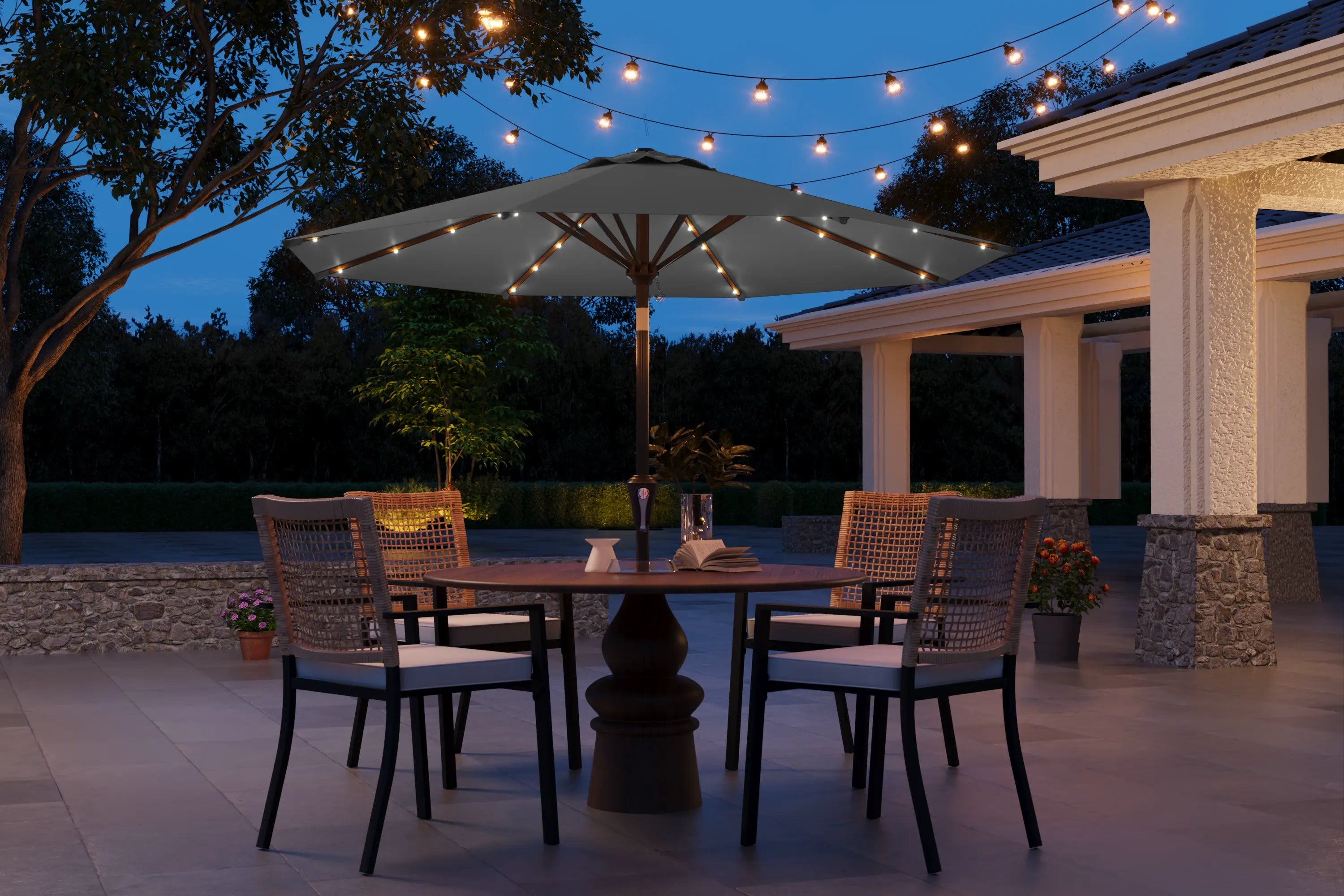 Outdoor patio setting with table, chairs, and string lights at dusk.