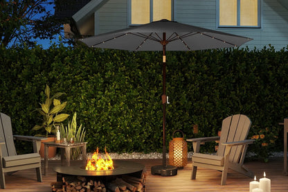 Outdoor patio setting with a fire pit, chairs, and an umbrella on a wooden deck.