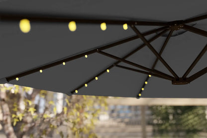 Dark outdoor umbrella with string lights against a blurred background