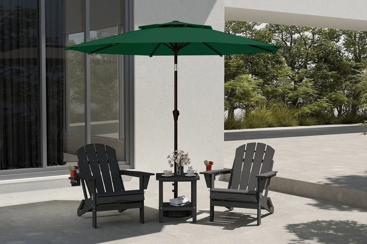 Outdoor patio set with two black chairs and a green umbrella on a concrete patio.