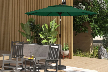 Outdoor patio set with green umbrella, chairs, and table on a wooden deck.