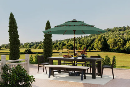 Outdoor dining set with table, chairs, and umbrella in a garden setting