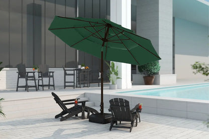Green patio umbrella on a stand with chairs and a table in an outdoor setting.