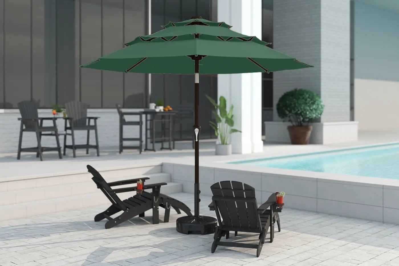 Green patio umbrella with black chairs and a pool in the background