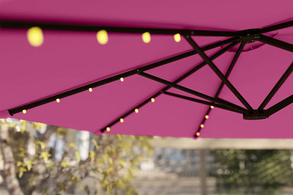Pink outdoor umbrella with string lights against a blurred background
