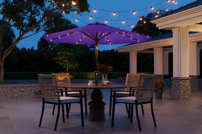 Outdoor patio setting with a purple umbrella, table, chairs, and string lights at dusk.